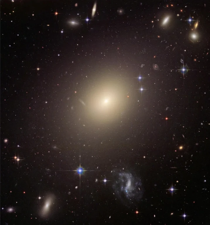 The huge elliptical galaxy ESO 325-G004 - shone 10,000 times brighter when it formed than it does today. These types of galaxies briefly lit up the entire universe – and contributed to the background radiation we can measure today.