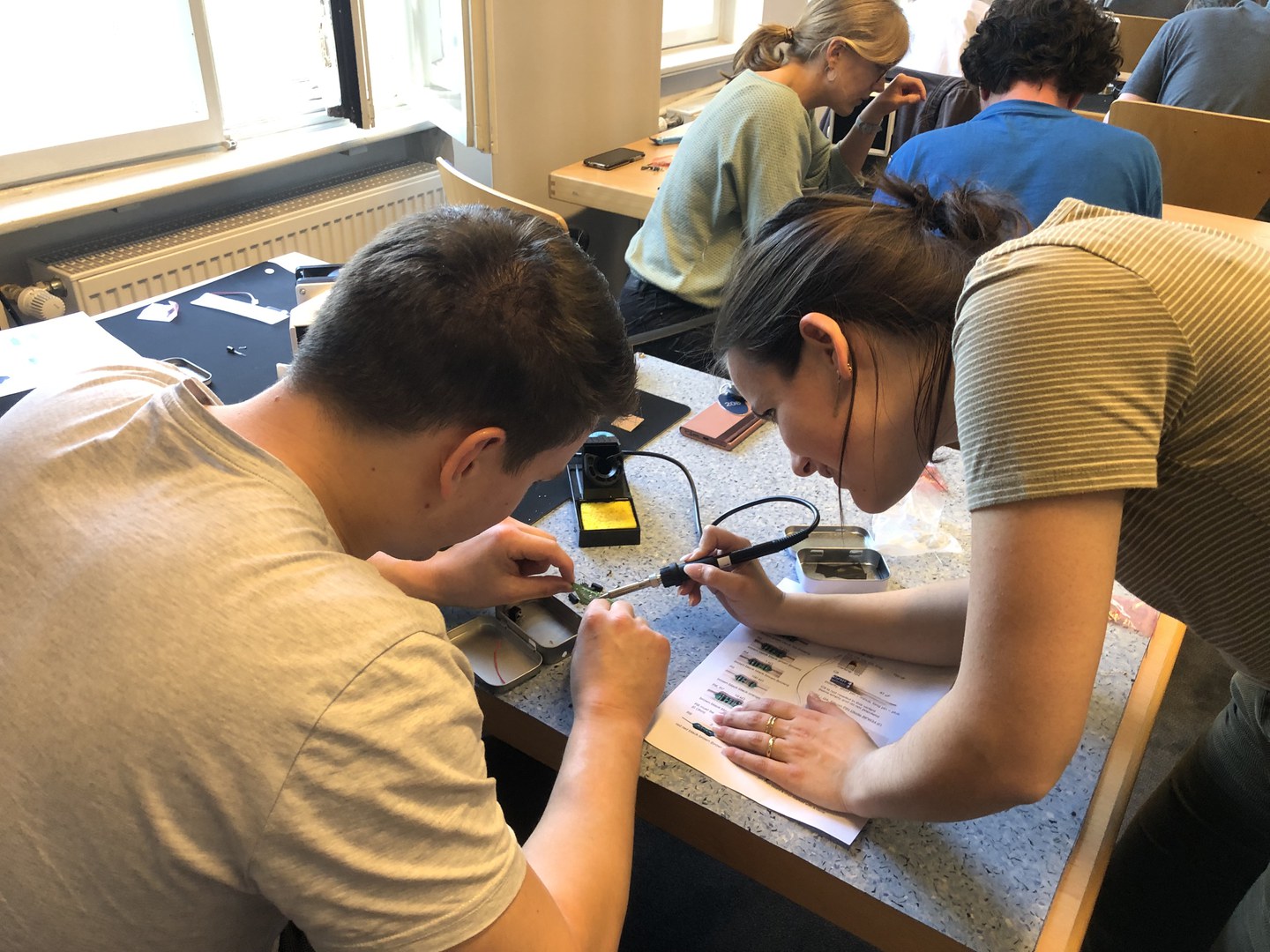 Students soldering at the workshop during the color meets flavor school